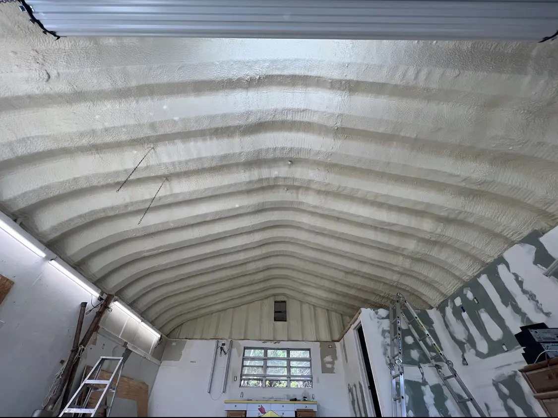 Spray polyurethane foam applied to the underside of a metal roof deck in Greenbriar